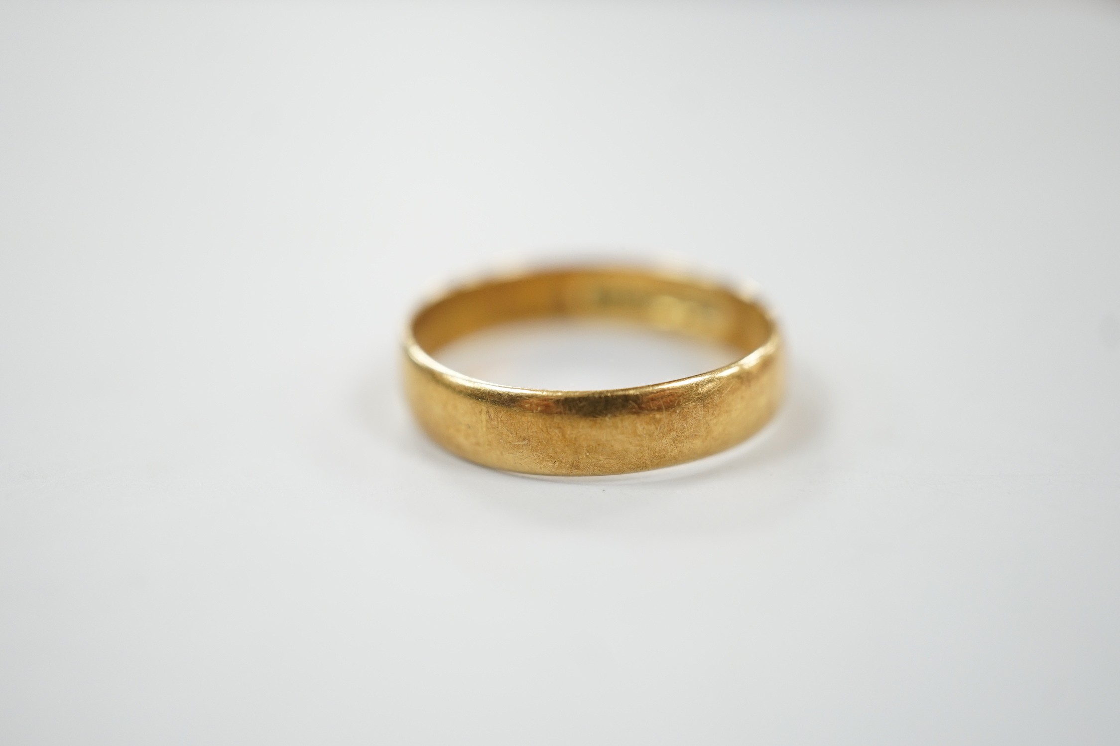 A 1960's 18ct gold wedding band, size P/Q, 3.3 grams, with engraved date to shank interior.